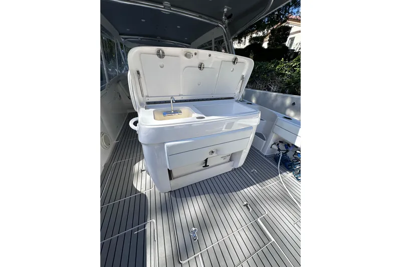 No Name Yacht Photos Pics 2020 Intrepid 409 Valor boat interior with open storage compartment and sink.