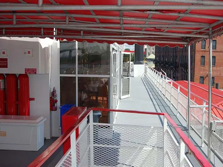 Capt. Jp III Yacht Photos Pics 1985 Custom Serodino Dinner Boat deck with red canopy and safety equipment.