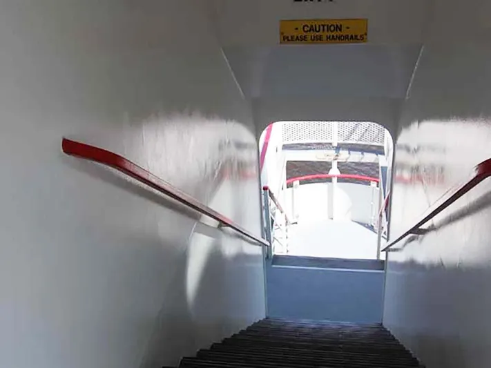 Capt. Jp III Yacht Photos Pics Stairway on 1985 Custom Serodino Dinner Boat with caution sign and handrails.