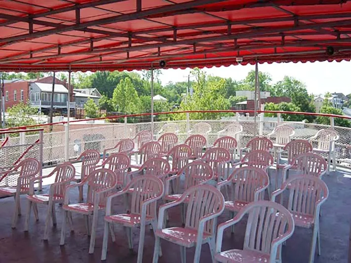 Capt. Jp III Yacht Photos Pics Upper deck of 1985 Custom Serodino Dinner Boat with white chairs and red canopy.
