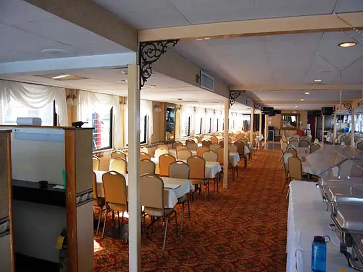 Capt. Jp III Yacht Photos Pics Interior of 1985 Custom Serodino Dinner Boat with elegant dining setup and ornate decor.