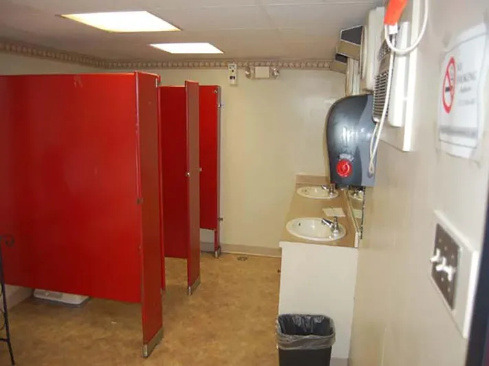 Capt. Jp III Yacht Photos Pics Public restroom with red stalls and sinks on a 1985 Custom Serodino Dinner Boat.
