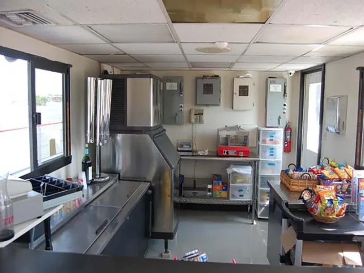 Capt. Jp III Yacht Photos Pics Interior of a 1985 Custom Serodino Dinner Boat kitchen with snacks and equipment.