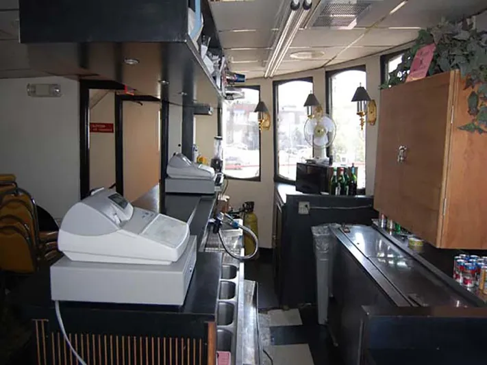 Capt. Jp III Yacht Photos Pics Interior of 1985 Custom Serodino Dinner Boat with bar area and cash registers.