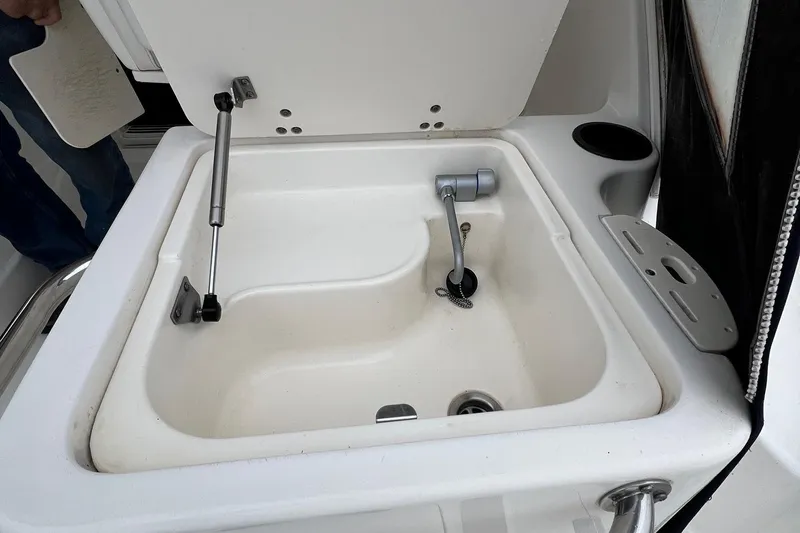 Rock N Reel Yacht Photos Pics Boston Whaler 305 Conquest 2005 boat sink with open lid and faucet.
