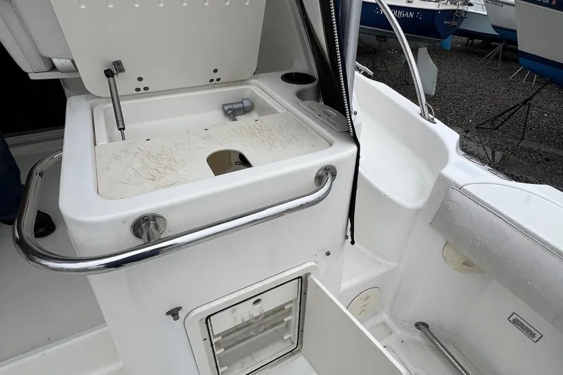 Rock N Reel Yacht Photos Pics 2005 Boston Whaler 305 Conquest boat interior with open storage compartment.