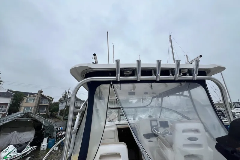 Rock N Reel Yacht Photos Pics 2005 Boston Whaler 305 Conquest boat with rod holders and clear cockpit cover.