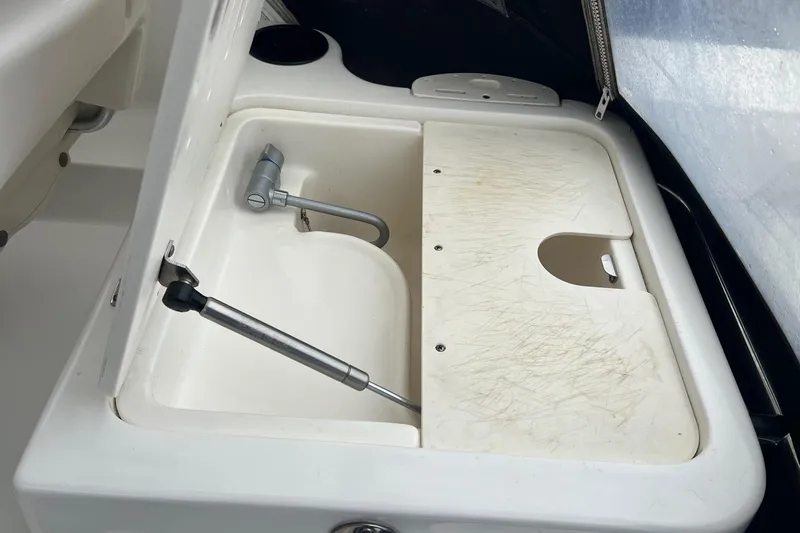 Rock N Reel Yacht Photos Pics 2005 Boston Whaler 305 Conquest sink with cutting board and faucet.