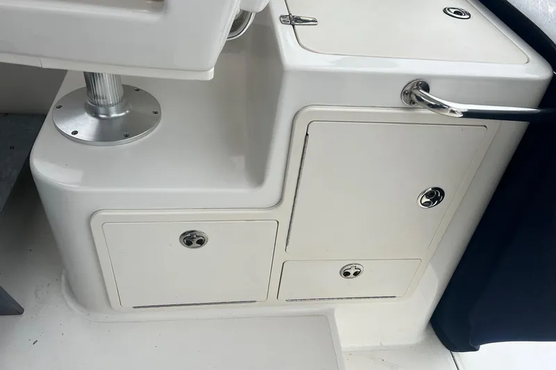 Rock N Reel Yacht Photos Pics 2005 Boston Whaler 305 Conquest interior storage compartments and seating base.