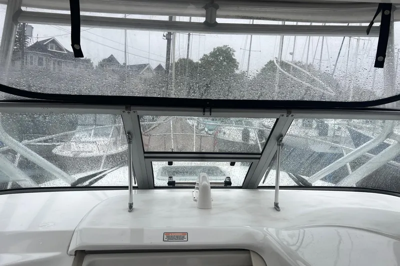 Rock N Reel Yacht Photos Pics Rainy view from 2005 Boston Whaler 305 Conquest boat cockpit, marina in background.
