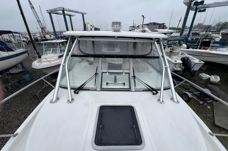 Rock N Reel Yacht Photos Pics 2005 Boston Whaler 305 Conquest boat on display at a marina.