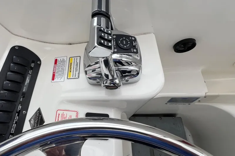 Rock N Reel Yacht Photos Pics Control panel of a 2005 Boston Whaler 305 Conquest boat with steering wheel.