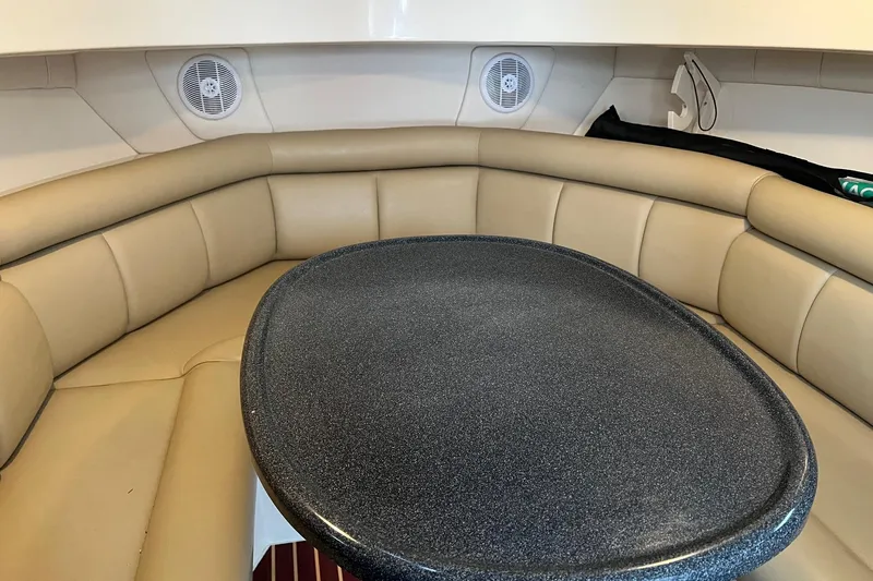 Rock N Reel Yacht Photos Pics Interior of 2005 Boston Whaler 305 Conquest with cushioned seating and oval table.