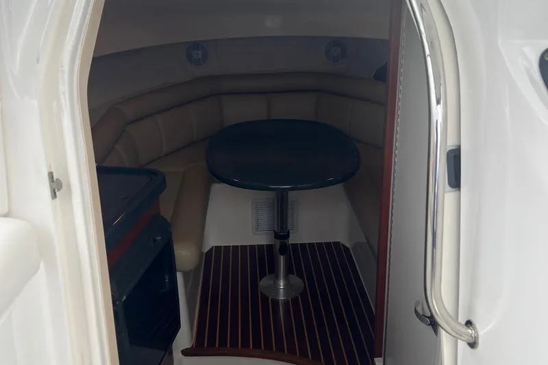 Rock N Reel Yacht Photos Pics 2005 Boston Whaler 305 Conquest cabin interior with seating and table.