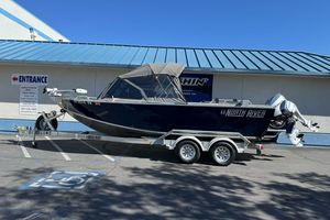 2023 North River 21 X 84 Seahawk boat on trailer, parked outside a building.