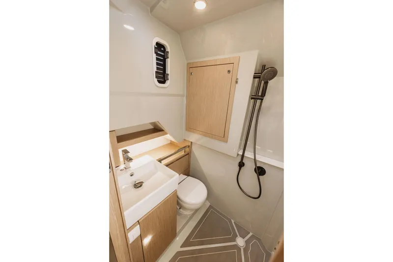  Yacht Photos Pics Modern bathroom in 2026 XO Boats EXPLR 44, featuring sleek fixtures and wood accents.
