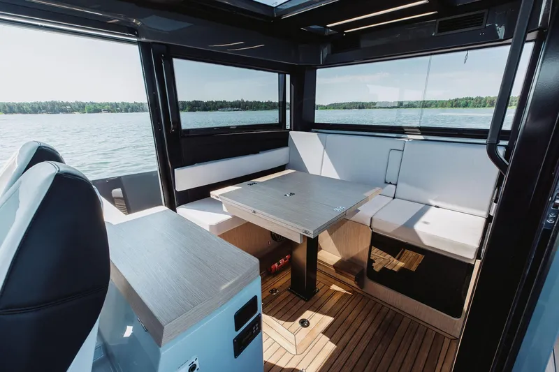  Yacht Photos Pics Interior of 2026 XO Boats EXPLR 44, featuring modern seating and table with scenic water view.
