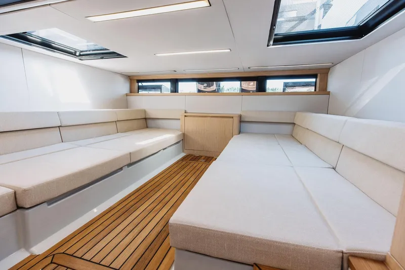  Yacht Photos Pics Luxurious interior of 2026 XO Boats EXPLR 44 with elegant seating and wooden flooring.