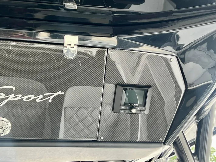  Yacht Photos Pics 2025 Nor-Tech 340 Sport Center Console dashboard with carbon fiber finish and audio controls.