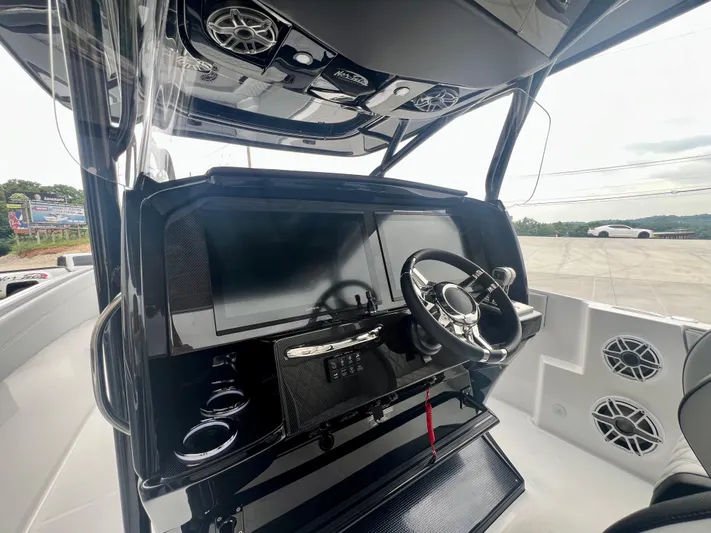  Yacht Photos Pics 2025 Nor-Tech 340 Sport Center Console dashboard with steering wheel and modern controls.