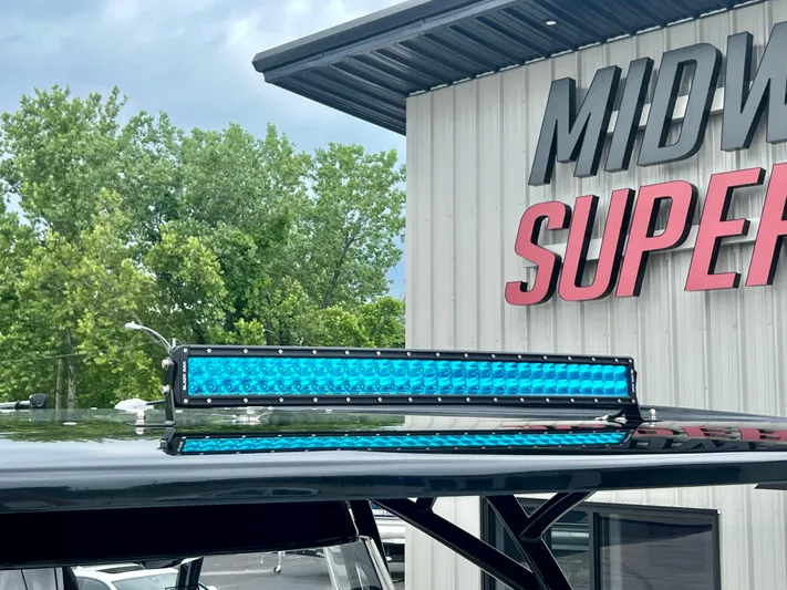  Yacht Photos Pics 2025 Nor-Tech 340 Sport Center Console with blue LED light bar, Midway Superstore background.