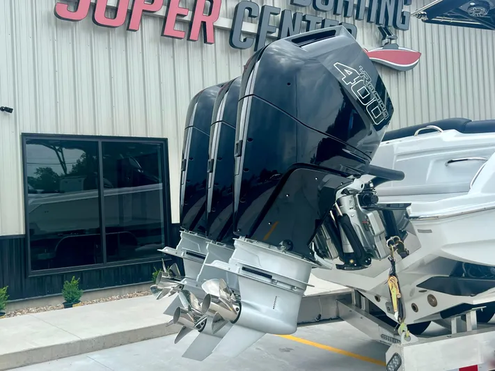  Yacht Photos Pics 2025 Nor-Tech 340 Sport Center Console with powerful outboard engines at a dealership.
