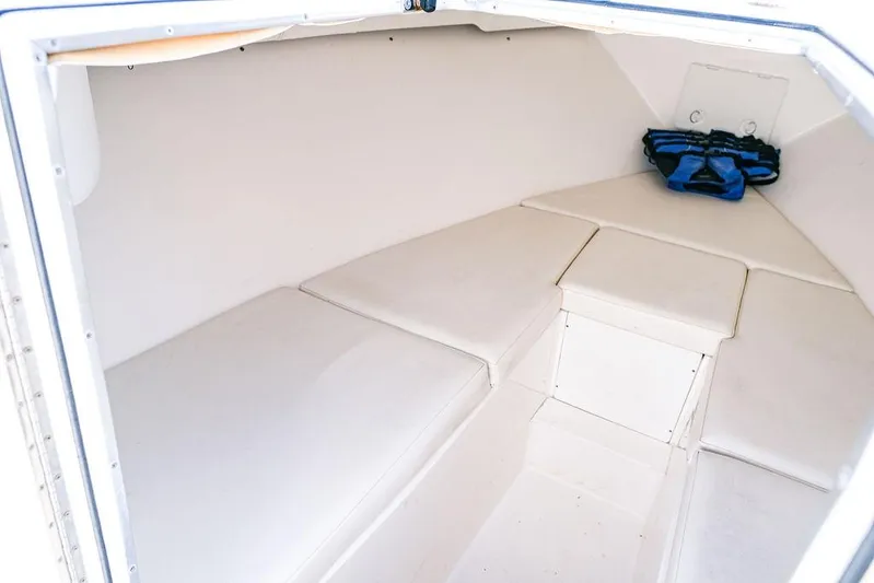  Yacht Photos Pics 2005 Fountain 38 CC Tournament Edition cabin interior with white cushioned seating.