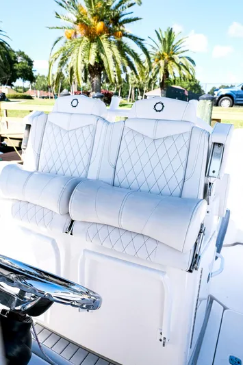  Yacht Photos Pics 2005 Fountain 38 CC Tournament Edition boat with luxurious white seating and palm trees in the background.