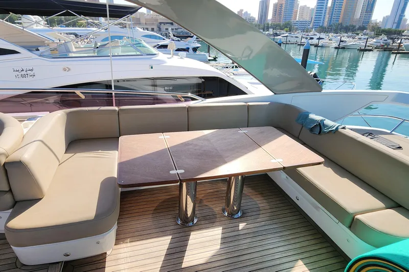 Yacht Photos Pics Luxurious 2019 Princess F62 yacht deck with seating and table, docked at marina.
