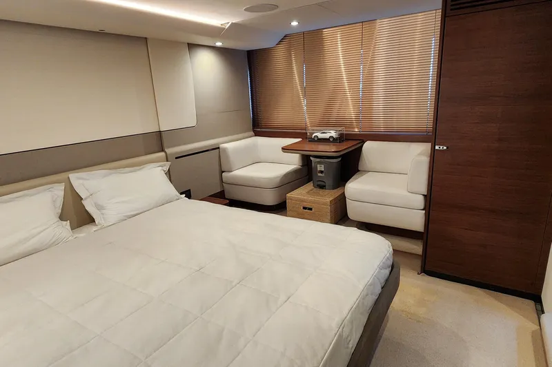  Yacht Photos Pics Luxurious 2019 Princess F62 yacht bedroom with modern decor and cozy seating area.