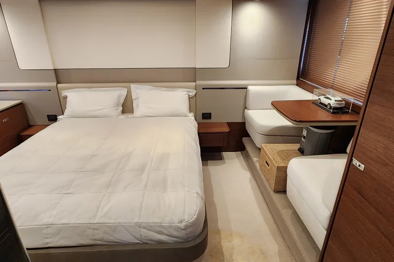  Yacht Photos Pics Luxurious 2019 Princess F62 yacht bedroom with modern decor and cozy seating area.