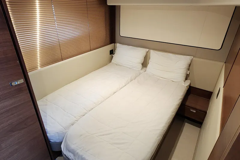  Yacht Photos Pics Luxurious twin cabin in 2019 Princess F62 yacht with modern decor and wooden accents.