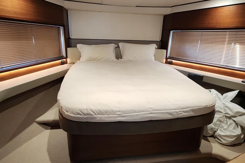  Yacht Photos Pics Luxurious bedroom interior of 2019 Princess F62 yacht with cozy bed and elegant design.