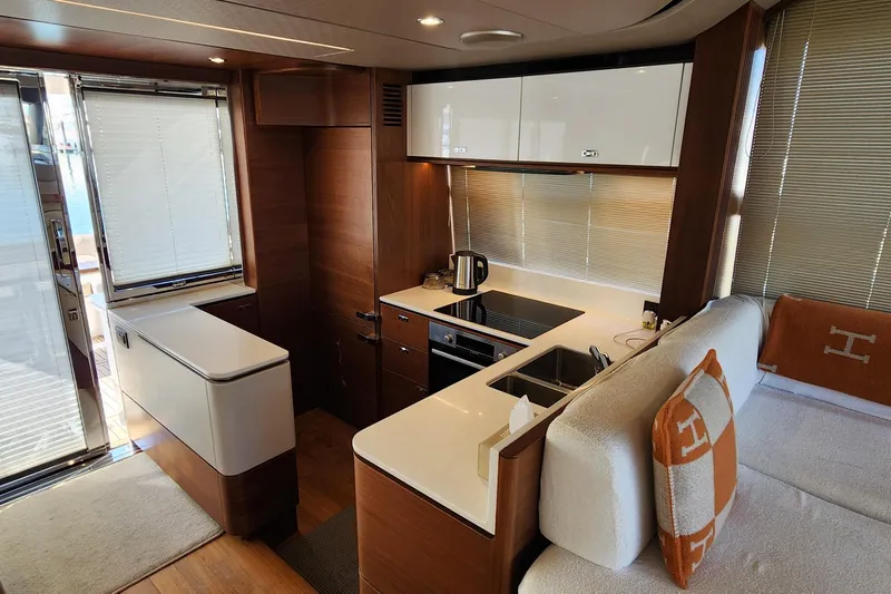  Yacht Photos Pics Luxurious 2019 Princess F62 yacht interior with modern kitchen and elegant wood finishes.
