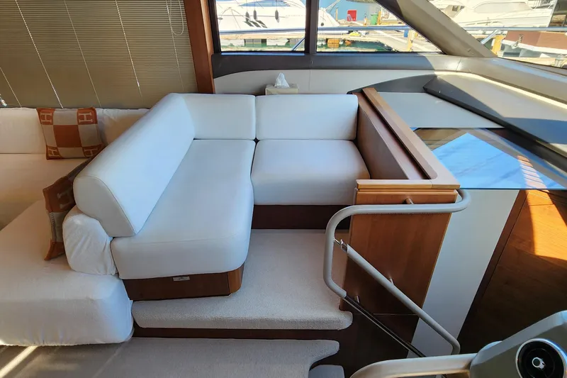  Yacht Photos Pics Luxurious interior of 2019 Princess F62 yacht with white seating and wooden accents.