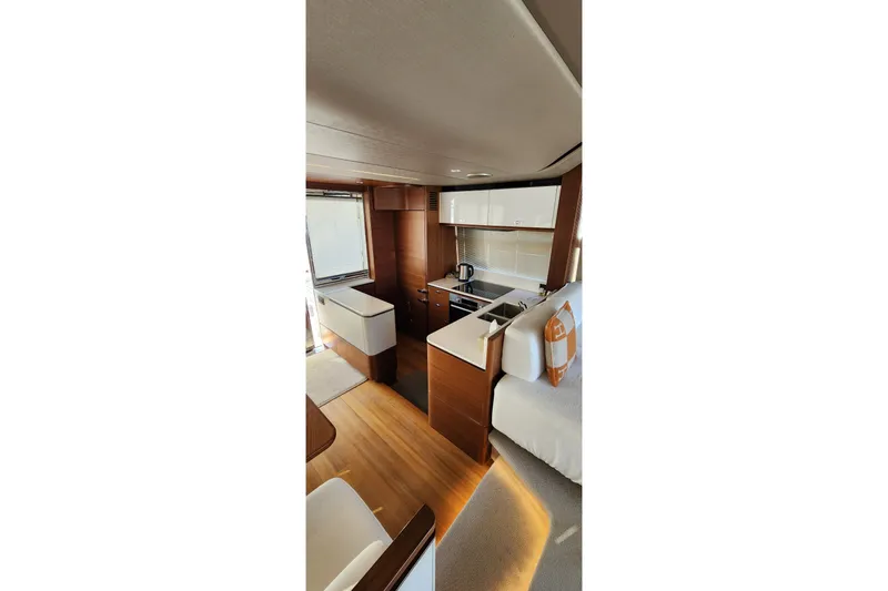  Yacht Photos Pics Luxurious interior of 2019 Princess F62 yacht with modern kitchen and seating area.
