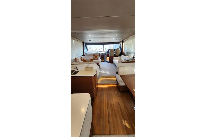  Yacht Photos Pics Luxurious interior of 2019 Princess F62 yacht with modern furnishings and wooden flooring.