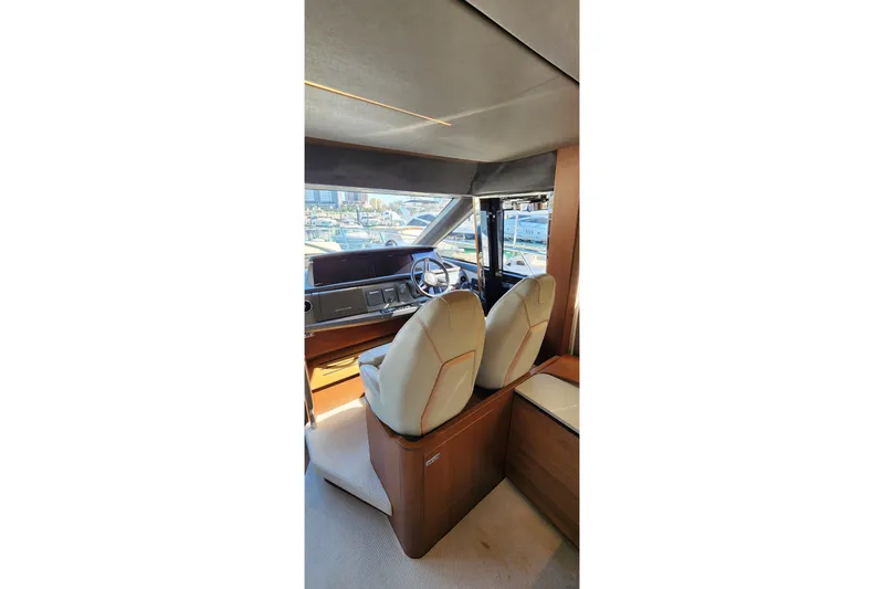  Yacht Photos Pics Interior of 2019 Princess F62 yacht with luxurious seating and helm station.