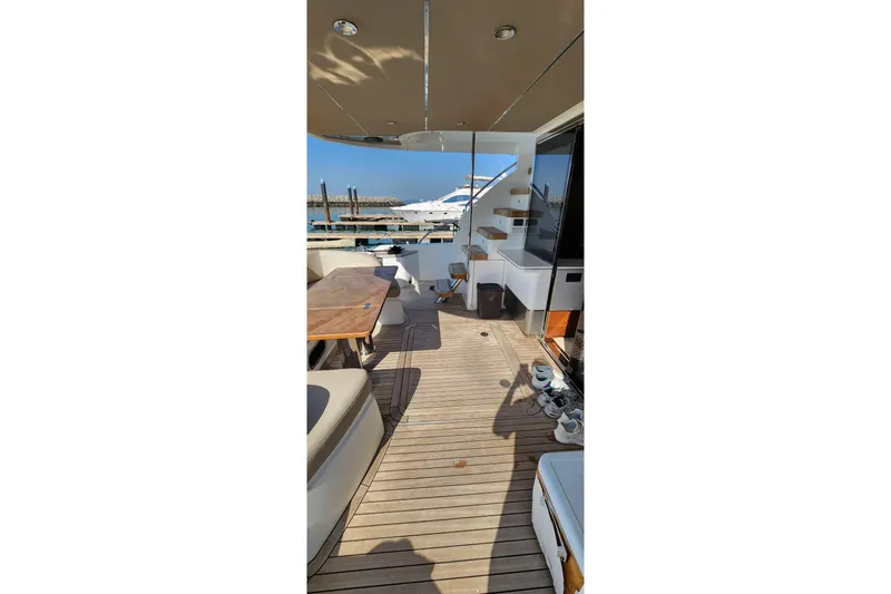  Yacht Photos Pics Luxurious 2019 Princess F62 yacht deck with seating and table, docked at marina.