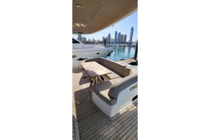  Yacht Photos Pics Luxury yacht Princess F62, 2019 model, with elegant outdoor seating and city skyline view.
