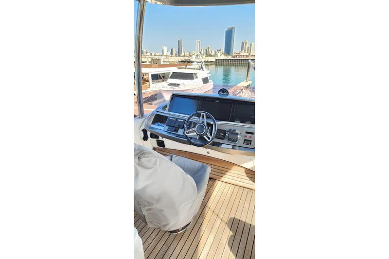  Yacht Photos Pics Helm of 2019 Princess F62 yacht with city skyline in background.