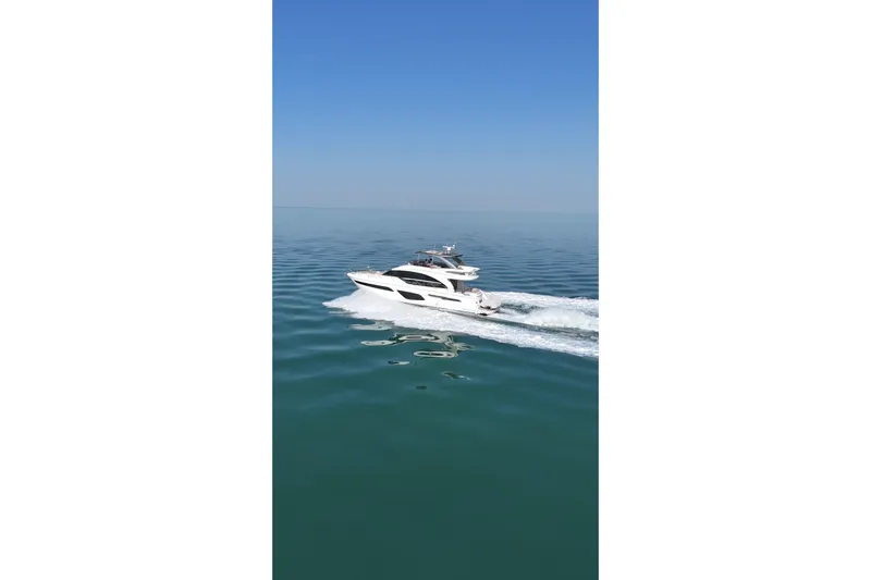  Yacht Photos Pics 2019 Princess F62 yacht cruising on calm blue ocean waters.