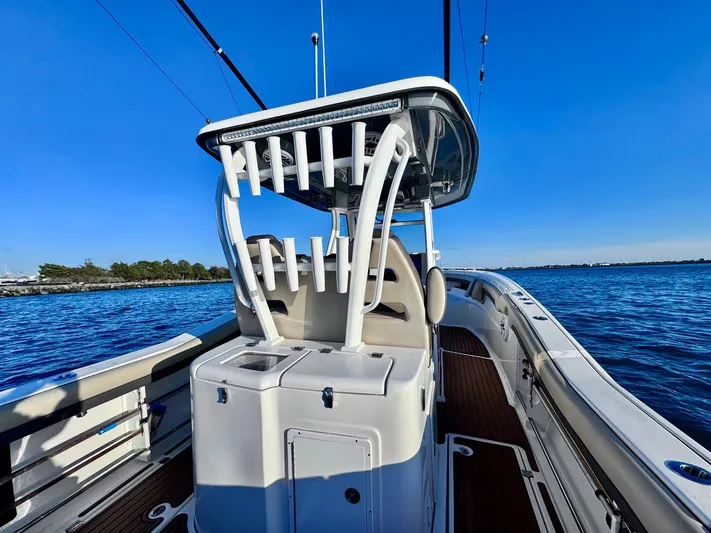 Suadha Yacht Photos Pics 2021 Tidewater 320 CC Adventure boat on calm blue water.