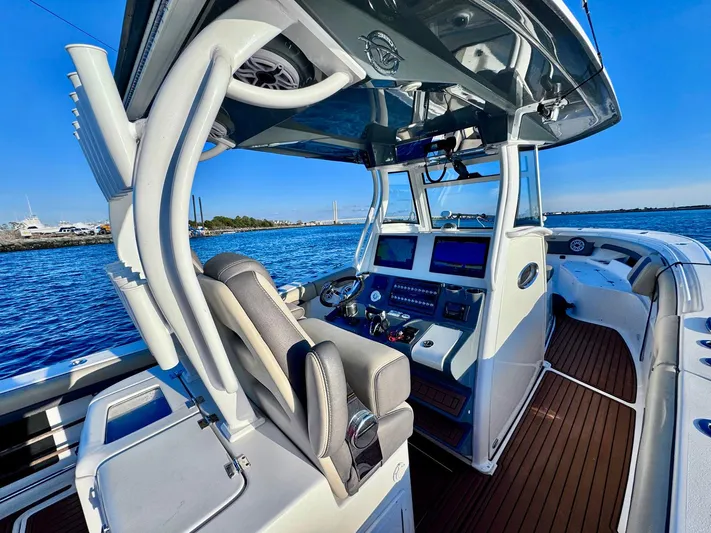Suadha Yacht Photos Pics 2021 Tidewater 320 CC Adventure boat cockpit with modern controls and ocean view.