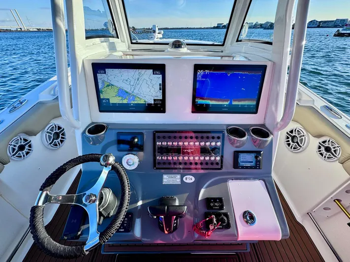 Suadha Yacht Photos Pics 2021 Tidewater 320 CC Adventure boat dashboard with navigation screens and controls.