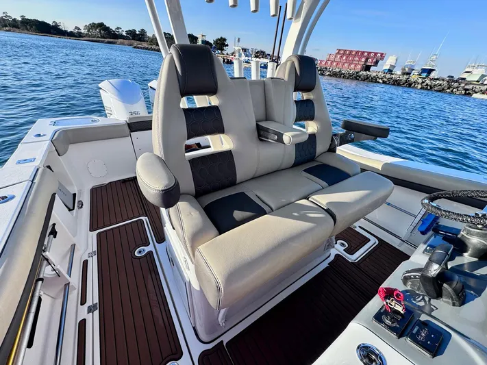 Suadha Yacht Photos Pics 2021 Tidewater 320 CC Adventure boat interior with comfortable seating and modern design.