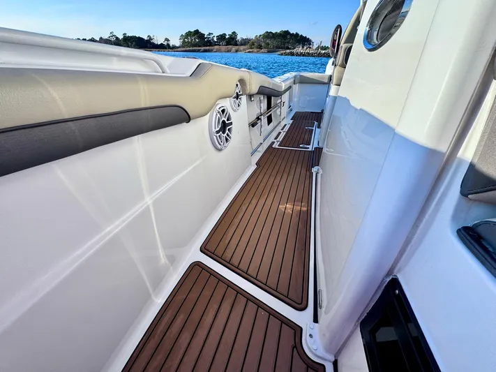 Suadha Yacht Photos Pics 2021 Tidewater 320 CC Adventure boat deck with wood finish and ocean view.