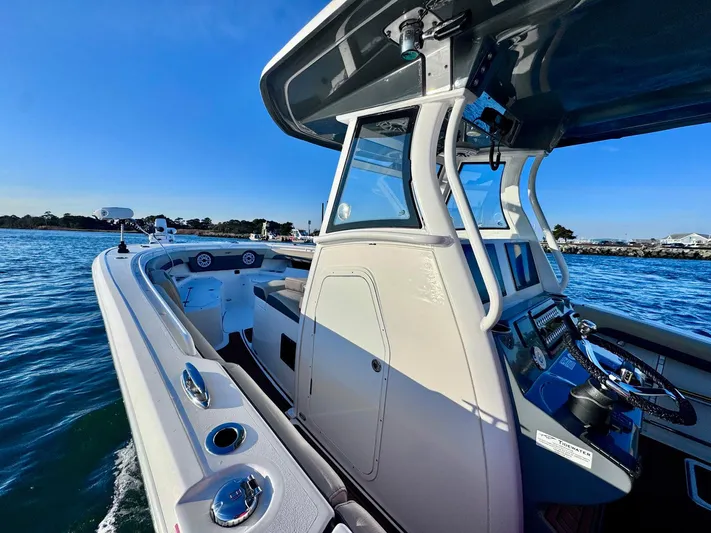Suadha Yacht Photos Pics 2021 Tidewater 320 CC Adventure boat on water, showcasing sleek design and advanced controls.