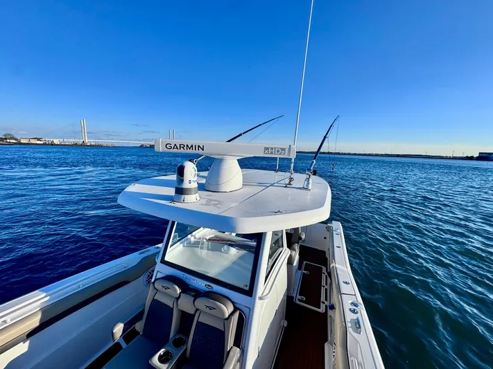 Suadha Yacht Photos Pics 2021 Tidewater 320 CC Adventure boat on open water, featuring Garmin radar.