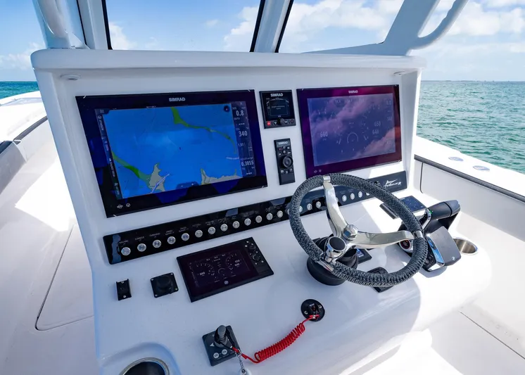  Yacht Photos Pics Control panel of 2025 Streamline R 35 boat with navigation screens and steering wheel.